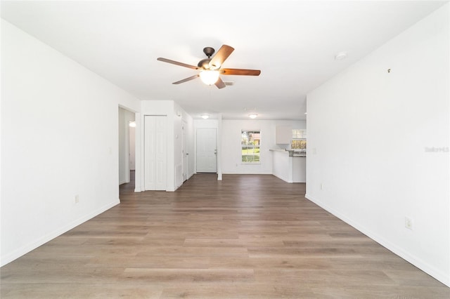 5596 NW 57th St, Ocala, FL 34482 - unfurnished living room featuring ceiling fan and light wood-style flooring