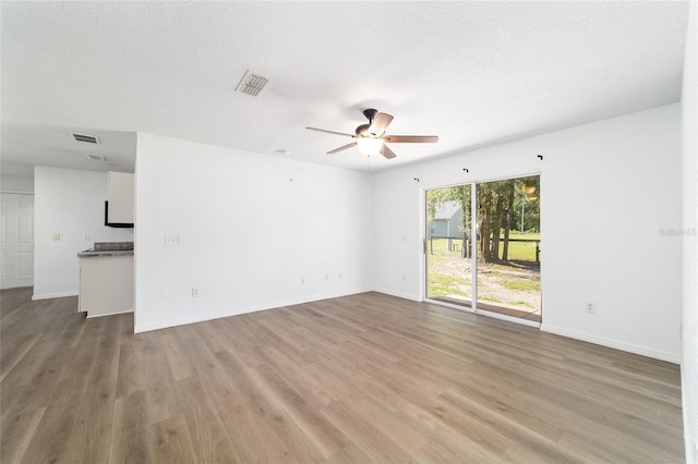5596 NW 57th St, Ocala, FL 34482 - unfurnished room with a ceiling fan, light wood-style flooring, and a textured ceiling