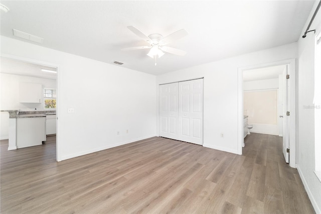 5596 NW 57th St, Ocala, FL 34482 - unfurnished bedroom with light wood-type flooring, a closet, and ceiling fan