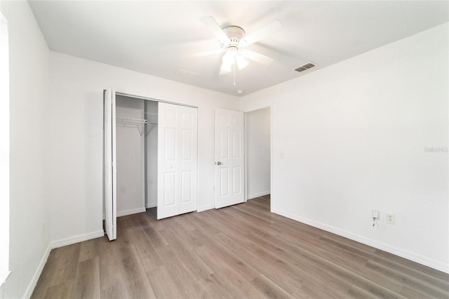 5596 NW 57th St, Ocala, FL 34482 - unfurnished bedroom featuring wood finished floors, a closet, and ceiling fan