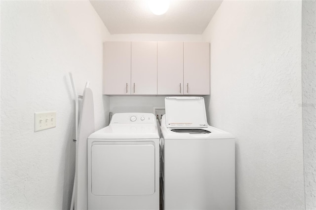 5596 NW 57th St, Ocala, FL 34482 - laundry area featuring cabinet space, independent washer and dryer, and a textured wall