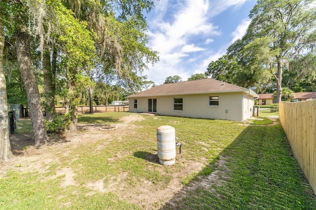 5596 NW 57th St, Ocala, FL 34482 - back of property featuring a fenced backyard and stucco siding