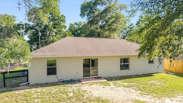 5596 NW 57th St, Ocala, FL 34482 - back of house featuring stucco siding and roof with shingles