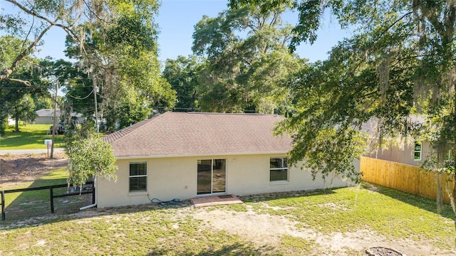 5596 NW 57th St, Ocala, FL 34482 - rear view of house with stucco siding and roof with shingles