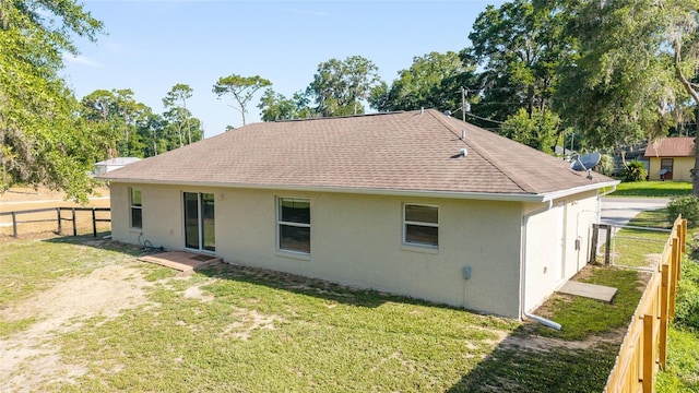5596 NW 57th St, Ocala, FL 34482 - back of property featuring stucco siding, a fenced backyard, and a shingled roof