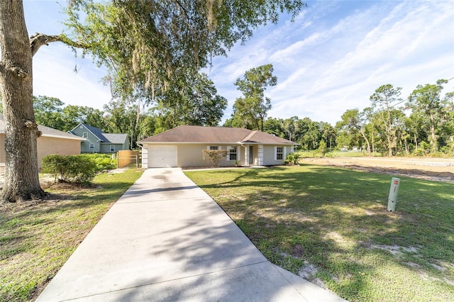 5596 NW 57th St, Ocala, FL 34482 - ranch-style house with driveway, a front lawn, an attached garage, and stucco siding