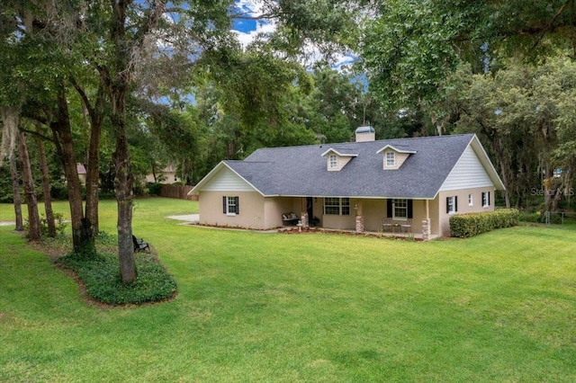 26 Count Fleet Dr, Ocala, FL 34482 - view of front facade with a chimney, a front yard, a porch, and view of scattered trees