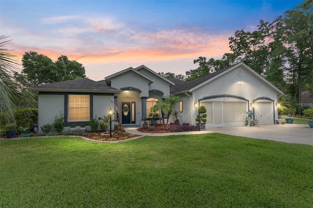 19115 SW 98th Loop, Dunnellon, FL 34432 - ranch-style home featuring stucco siding, concrete driveway, a garage, a yard, and roof with shingles