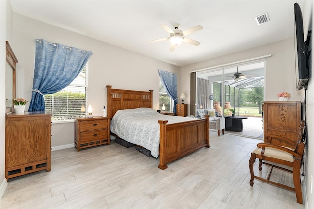 19115 SW 98th Loop, Dunnellon, FL 34432 - bedroom featuring access to outside, light wood-type flooring, and a ceiling fan