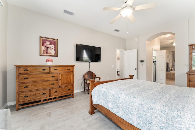 19115 SW 98th Loop, Dunnellon, FL 34432 - bedroom featuring arched walkways, light wood-style flooring, and a ceiling fan