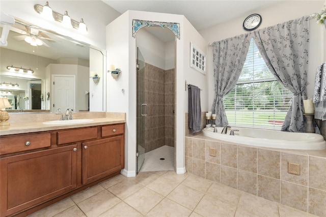19115 SW 98th Loop, Dunnellon, FL 34432 - bathroom featuring vanity, tile patterned flooring, a garden tub, a stall shower, and a ceiling fan
