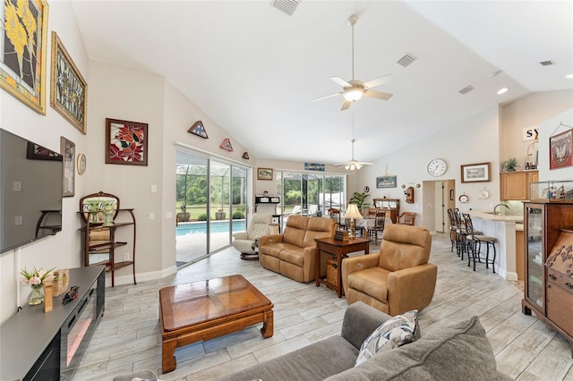 19115 SW 98th Loop, Dunnellon, FL 34432 - living area featuring a ceiling fan, light wood-type flooring, high vaulted ceiling, beverage cooler, and recessed lighting