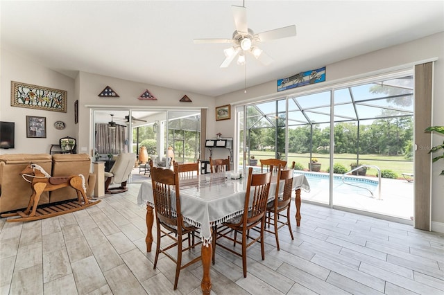 19115 SW 98th Loop, Dunnellon, FL 34432 - dining room with ceiling fan, a sunroom, vaulted ceiling, and wood tiled floors