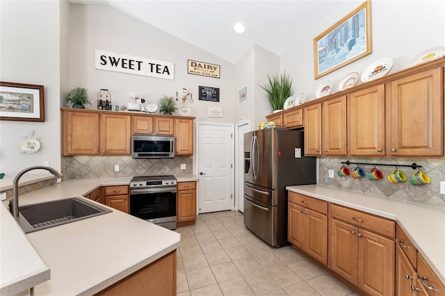 19115 SW 98th Loop, Dunnellon, FL 34432 - kitchen featuring appliances with stainless steel finishes, backsplash, light tile patterned flooring, light countertops, and high vaulted ceiling