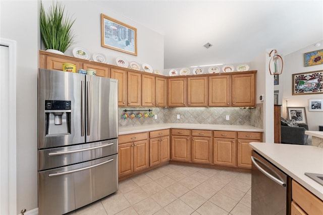 19115 SW 98th Loop, Dunnellon, FL 34432 - kitchen featuring appliances with stainless steel finishes, light countertops, light tile patterned floors, and backsplash