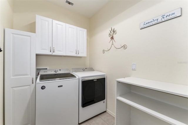 19115 SW 98th Loop, Dunnellon, FL 34432 - washroom with cabinet space, separate washer and dryer, and light tile patterned flooring