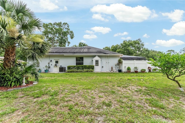 19115 SW 98th Loop, Dunnellon, FL 34432 - rear view of house featuring stucco siding and a yard