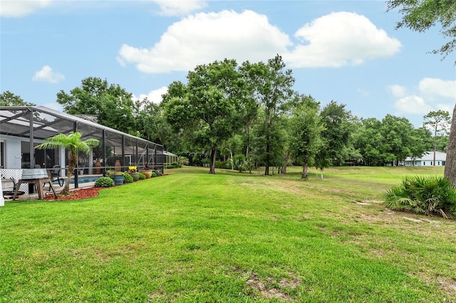 19115 SW 98th Loop, Dunnellon, FL 34432 - view of green lawn with an outdoor pool and a lanai