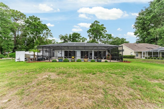 19115 SW 98th Loop, Dunnellon, FL 34432 - rear view of property with a lawn and a lanai