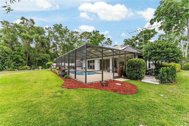 19115 SW 98th Loop, Dunnellon, FL 34432 - rear view of property with an outdoor pool, a lawn, a patio area, and glass enclosure