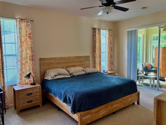 19480 SW 100th Loop, Dunnellon, FL 34432 - bedroom featuring light colored carpet, multiple windows, access to exterior, and a ceiling fan