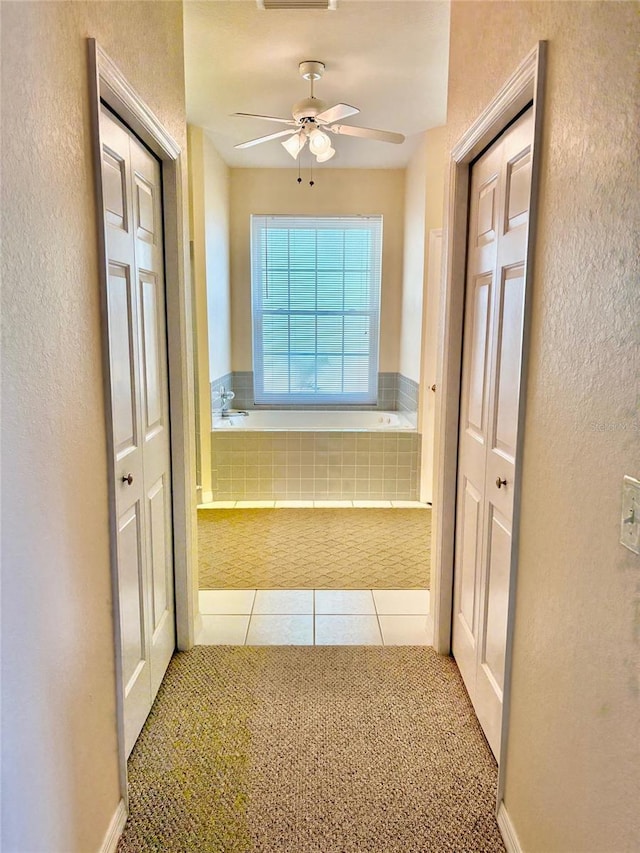 19480 SW 100th Loop, Dunnellon, FL 34432 - corridor featuring a textured wall, tile patterned floors, and carpet floors