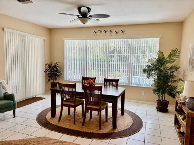 19480 SW 100th Loop, Dunnellon, FL 34432 - dining space with ceiling fan and light tile patterned flooring