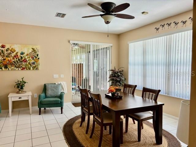 19480 SW 100th Loop, Dunnellon, FL 34432 - dining space with ceiling fan and light tile patterned floors