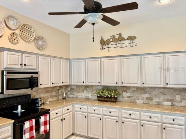 19480 SW 100th Loop, Dunnellon, FL 34432 - kitchen featuring stainless steel microwave, black range with electric stovetop, ceiling fan, and tasteful backsplash