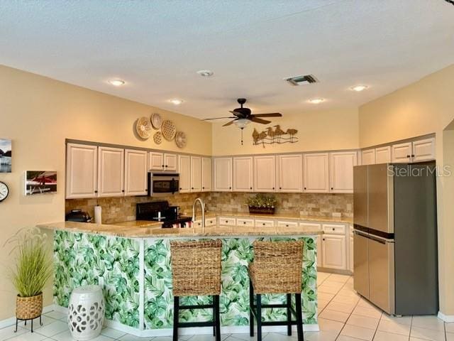 19480 SW 100th Loop, Dunnellon, FL 34432 - kitchen featuring appliances with stainless steel finishes, light countertops, ceiling fan, and light tile patterned flooring
