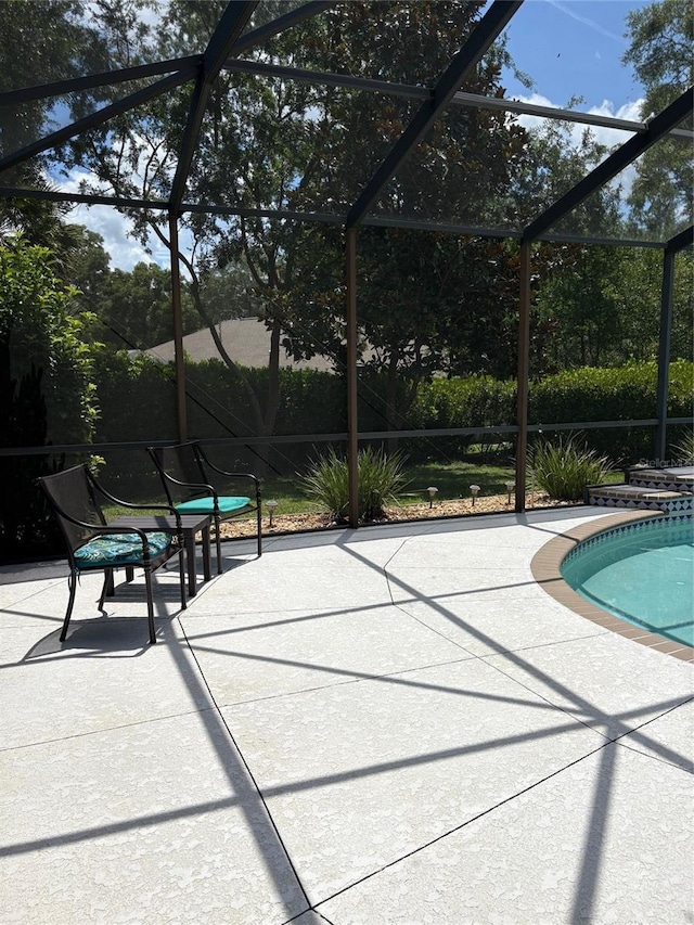 19480 SW 100th Loop, Dunnellon, FL 34432 - swimming pool featuring a patio area and glass enclosure