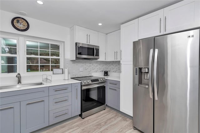 510 SE 19th St, Ocala, FL 34471 - kitchen with appliances with stainless steel finishes, gray cabinets, light countertops, light wood finished floors, and recessed lighting