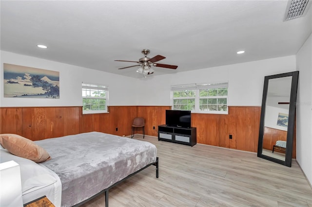 510 SE 19th St, Ocala, FL 34471 - bedroom with a wainscoted wall, wood walls, wood finished floors, recessed lighting, and ceiling fan