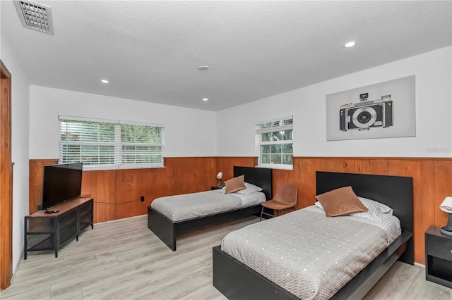 510 SE 19th St, Ocala, FL 34471 - bedroom with a wainscoted wall, multiple windows, wood walls, wood finished floors, and recessed lighting