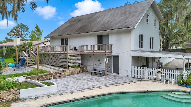 510 SE 19th St, Ocala, FL 34471 - back of property with a patio, a deck, stairway, an outdoor pool, and roof with shingles