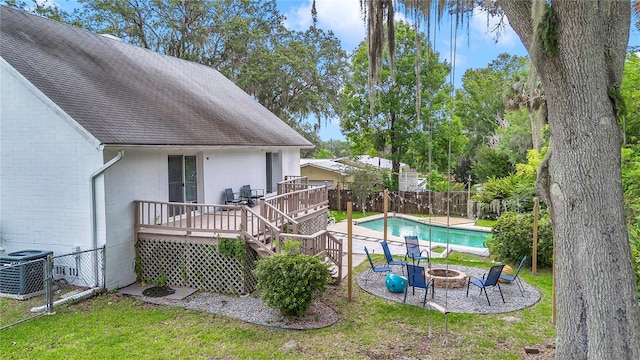 510 SE 19th St, Ocala, FL 34471 - view of swimming pool with an outdoor fire pit, a wooden deck, a fenced backyard, and a patio area