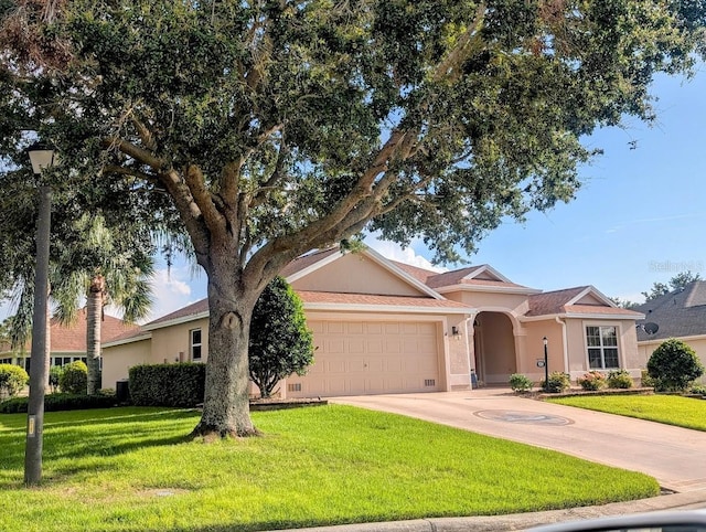 2721 Day Lily Run, The Villages, FL 32162 - view of front facade with a garage, stucco siding, a front yard, and concrete driveway