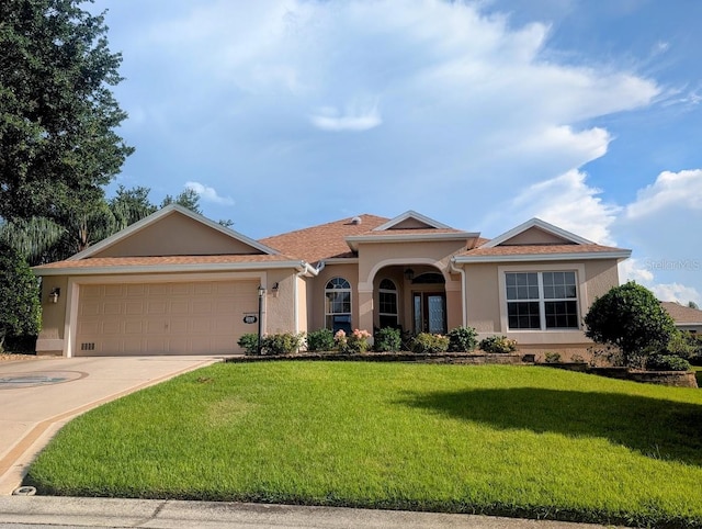 2721 Day Lily Run, The Villages, FL 32162 - view of front of property featuring stucco siding, a front lawn, driveway, and a garage