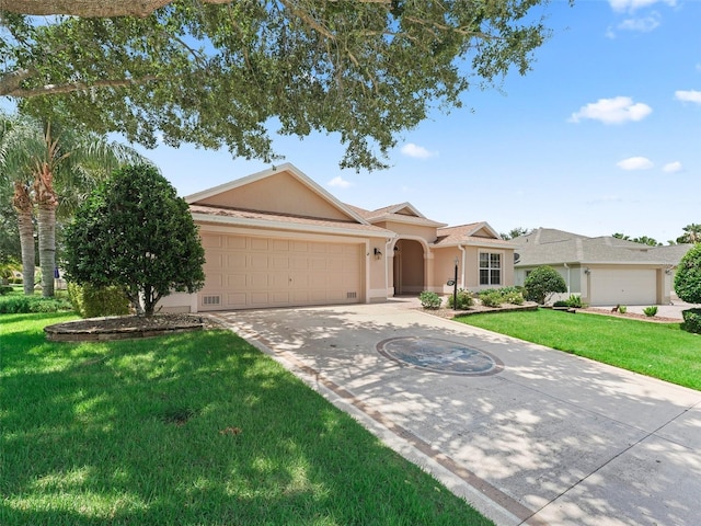 2721 Day Lily Run, The Villages, FL 32162 - view of front of home with stucco siding, an attached garage, concrete driveway, and a front lawn