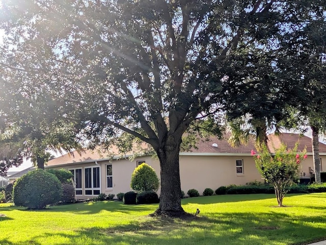 2721 Day Lily Run, The Villages, FL 32162 - view of property exterior featuring a lawn and stucco siding