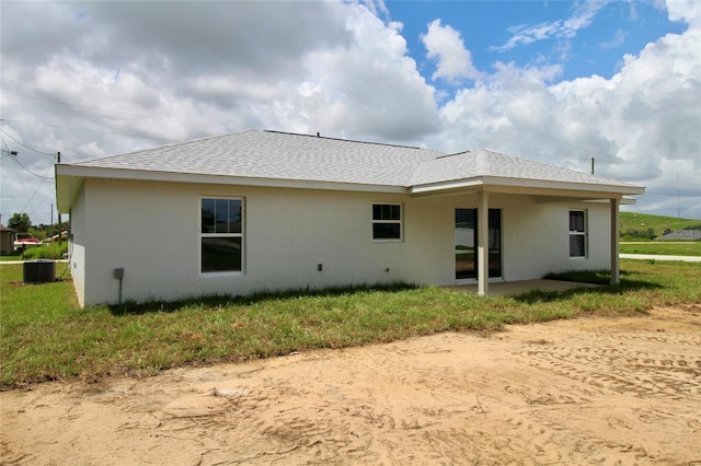 9 Hemlock Terrace Ln, Ocala, FL 34472 - back of house with stucco siding, a patio area, and roof with shingles