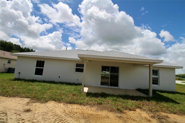 9 Hemlock Terrace Ln, Ocala, FL 34472 - rear view of house with stucco siding, a patio area, and a lawn