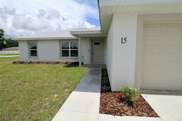 9 Hemlock Terrace Ln, Ocala, FL 34472 - entrance to property with a garage, a yard, a shingled roof, and stucco siding