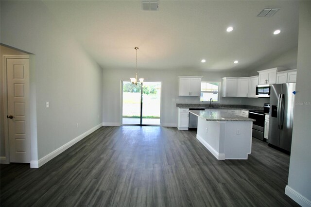 9 Hemlock Terrace Ln, Ocala, FL 34472 - kitchen with appliances with stainless steel finishes, a chandelier, a center island, dark wood-type flooring, and white cabinetry