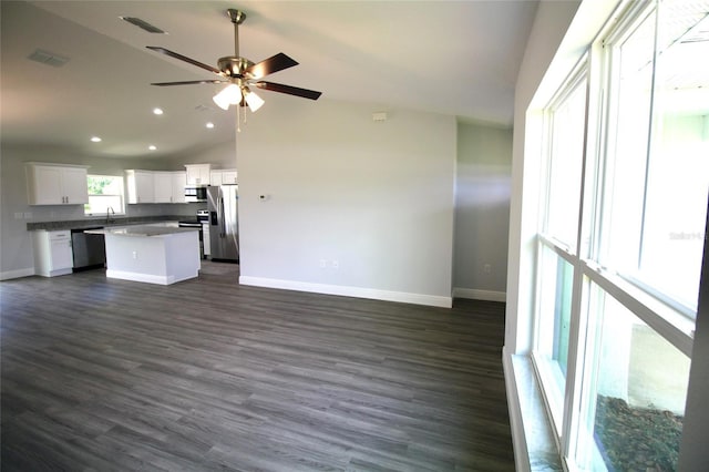 9 Hemlock Terrace Ln, Ocala, FL 34472 - kitchen featuring stainless steel appliances, a center island, vaulted ceiling, open floor plan, and white cabinetry
