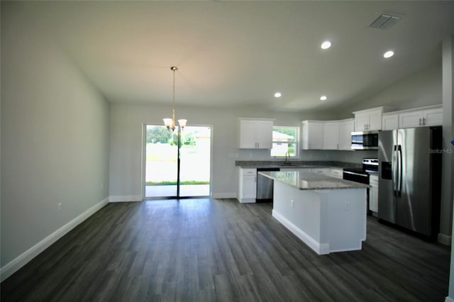 9 Hemlock Terrace Ln, Ocala, FL 34472 - kitchen with appliances with stainless steel finishes, a chandelier, a kitchen island, dark wood-style flooring, and recessed lighting