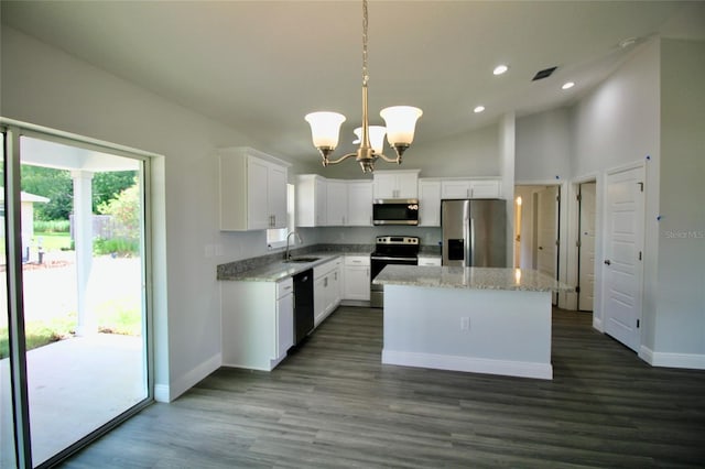 9 Hemlock Terrace Ln, Ocala, FL 34472 - kitchen with stainless steel appliances, a chandelier, a center island, recessed lighting, and white cabinetry