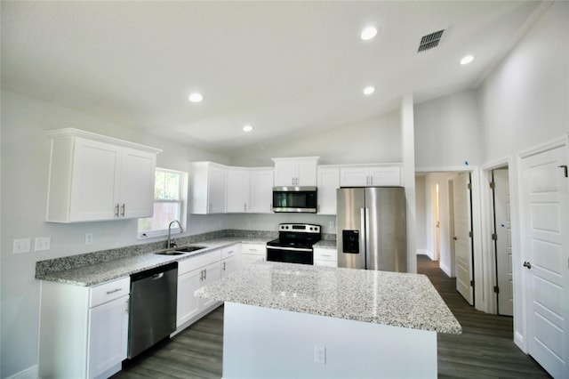 9 Hemlock Terrace Ln, Ocala, FL 34472 - kitchen featuring stainless steel appliances, lofted ceiling, a kitchen island, white cabinetry, and recessed lighting