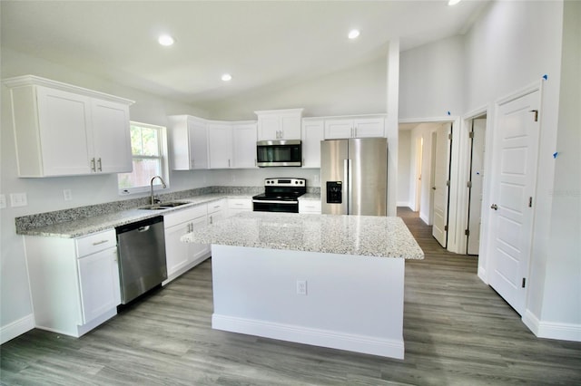 9 Hemlock Terrace Ln, Ocala, FL 34472 - kitchen featuring stainless steel appliances, a kitchen island, white cabinets, recessed lighting, and light stone countertops