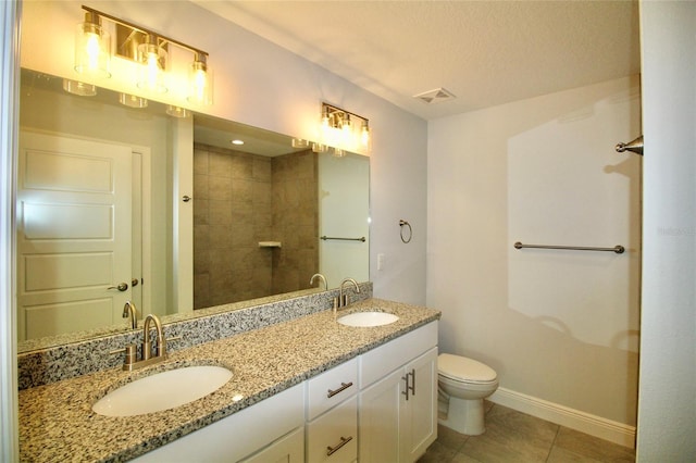 9 Hemlock Terrace Ln, Ocala, FL 34472 - full bath featuring double vanity, tile patterned floors, tiled shower, and a textured ceiling